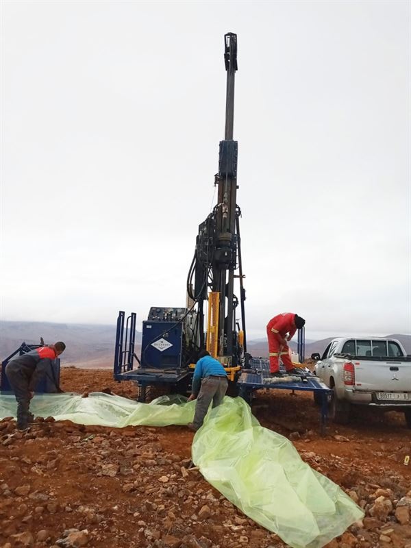 A group of men working on a machineAI-generated content may be incorrect.